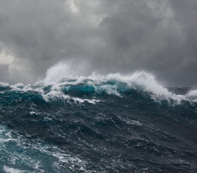 Dark, ominous ocean waves representing emotional and societal division