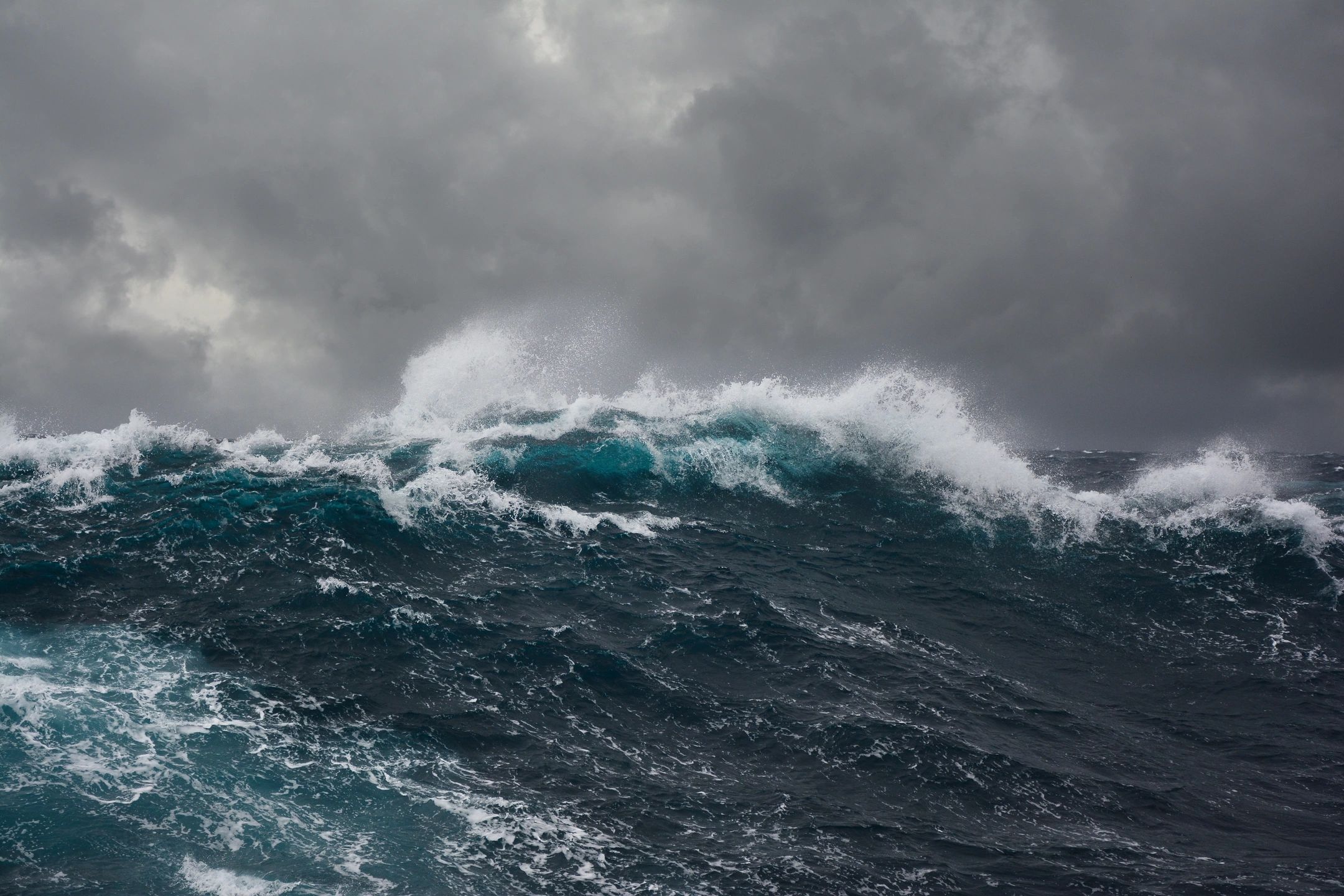 Dark, ominous ocean waves representing emotional and societal division